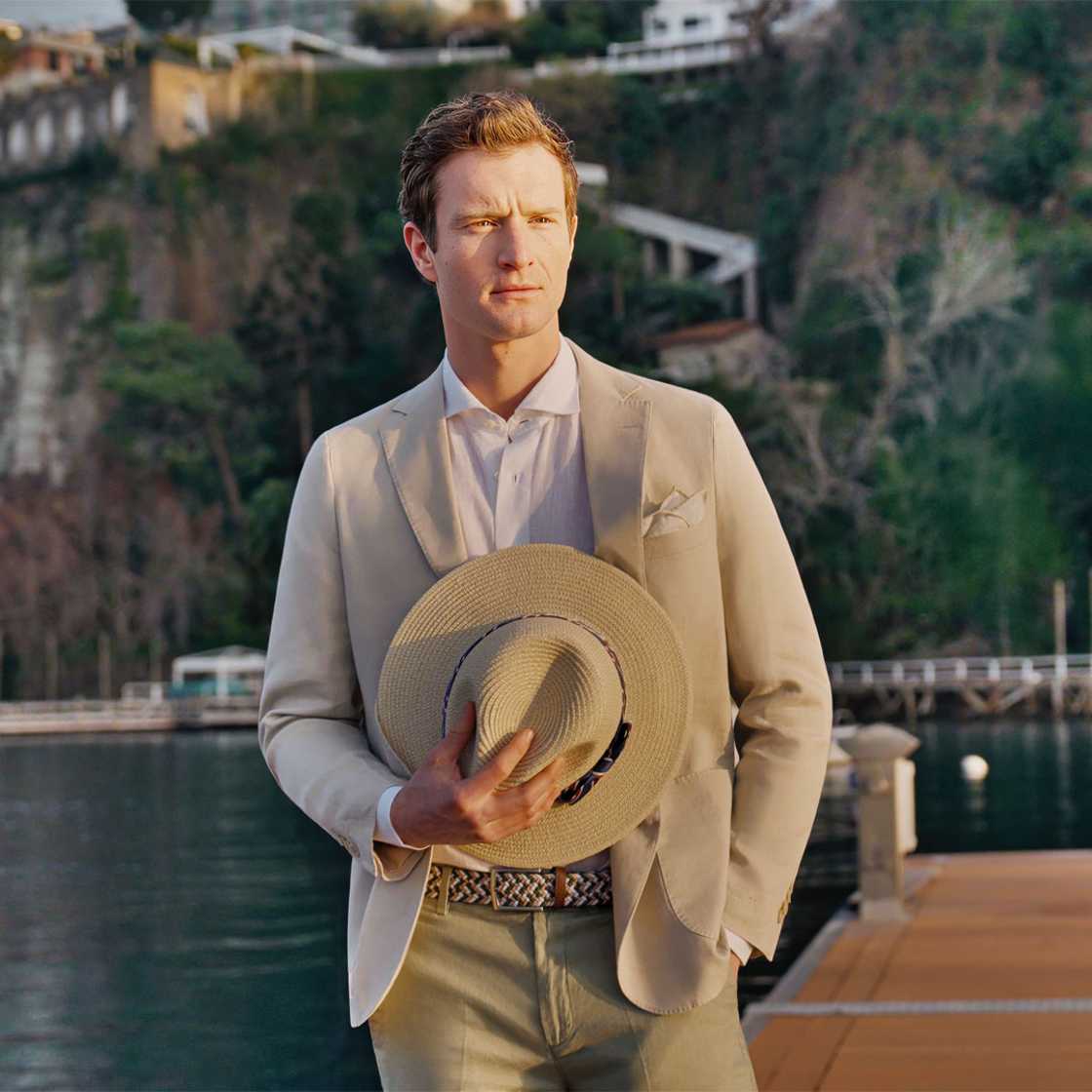 Spada man in a suit holding a hat